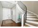 Elegant foyer with hardwood floors, curved staircase, and natural light at 10601 Chadsworth Ln, Highlands Ranch, CO 80126
