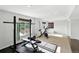 Home gym featuring weightlifting equipment, an exercise bike, and ample natural light at 10601 Chadsworth Ln, Highlands Ranch, CO 80126