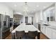Bright, modern kitchen with a large central island, stainless steel appliances, and elegant white cabinetry at 10601 Chadsworth Ln, Highlands Ranch, CO 80126