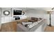 Cozy living room with a gray sectional sofa, built-in fireplace, and decorative wall mirrors at 10601 Chadsworth Ln, Highlands Ranch, CO 80126