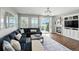 Comfortable living room featuring a large sectional sofa, hardwood floors, large windows, and a fireplace at 10601 Chadsworth Ln, Highlands Ranch, CO 80126