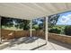 Covered patio with stone pillars, a wooden fence, and views of a lush, grassy landscape at 10601 Chadsworth Ln, Highlands Ranch, CO 80126