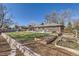 Large backyard with a patio, garden beds, and plenty of space for recreation and gardening at 2674 S Krameria St, Denver, CO 80222