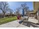 Backyard featuring a patio with outdoor furniture, a well-maintained lawn, and mature trees for shade at 2674 S Krameria St, Denver, CO 80222