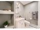Stylish bathroom featuring a modern vanity, round mirror, and open shelving for decor at 2674 S Krameria St, Denver, CO 80222