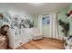 Charming Bedroom features unique wallpaper, hardwood floors, and ample natural light at 2674 S Krameria St, Denver, CO 80222