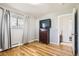 Bedroom with hardwood floors, closet, and neutral paint, offering a serene living space at 2674 S Krameria St, Denver, CO 80222