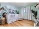 Charming Bedroom features unique wallpaper, hardwood floors, and ample natural light at 2674 S Krameria St, Denver, CO 80222