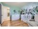 Charming Bedroom features unique wallpaper, hardwood floors, and ample storage at 2674 S Krameria St, Denver, CO 80222