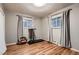 Bright bedroom featuring hardwood floors, neutral paint, and windows allowing natural light at 2674 S Krameria St, Denver, CO 80222