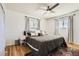 Bright bedroom with hardwood floors, ceiling fan, and neutral tones offering a calm space at 2674 S Krameria St, Denver, CO 80222