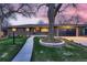 Charming brick home with a well-maintained front yard and a large tree as a focal point at 2674 S Krameria St, Denver, CO 80222