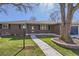 Charming brick home featuring manicured lawn, mature tree, and inviting walkway to front door at 2674 S Krameria St, Denver, CO 80222