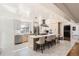 Modern kitchen with stainless steel appliances, quartz countertops, an island with seating, and sleek cabinetry at 2674 S Krameria St, Denver, CO 80222