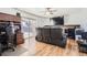 Comfortable living room with a large screen TV, wood floors, and a sliding glass door at 2674 S Krameria St, Denver, CO 80222