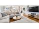 Bright and open living room with hardwood floors, stylish furniture, and an open concept design leading to the kitchen at 2674 S Krameria St, Denver, CO 80222
