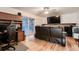 Cozy living room features wood flooring, home office setup, and access to the outdoor patio at 2674 S Krameria St, Denver, CO 80222