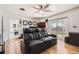 Inviting living room with a large reclining sofa, wood floors, and a view to the backyard at 2674 S Krameria St, Denver, CO 80222