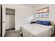 Neat bedroom with closet, window, neutral colors and cozy carpet at 4045 Shoshone St, Denver, CO 80211