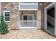 Private balcony area with stone exterior, white railing, and pebble landscaping at 1881 S Dunkirk St # 106, Aurora, CO 80017