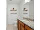 A bright bathroom features a granite countertop, shelving and neutral tiled floors, creating a peaceful space at 1881 S Dunkirk St # 106, Aurora, CO 80017