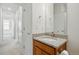 A clean bathroom features a granite countertop, a mirror, and neutral tiled floors, creating a peaceful space at 1881 S Dunkirk St # 106, Aurora, CO 80017