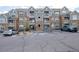 Attractive condo building with gray and stone facade, balconies, and convenient parking at 1881 S Dunkirk St # 106, Aurora, CO 80017