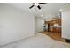 Open-concept living room with carpet and adjacent kitchen at 1881 S Dunkirk St # 106, Aurora, CO 80017