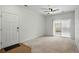 Neutral living room with door, balcony access, and ceiling fan at 1881 S Dunkirk St # 106, Aurora, CO 80017