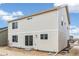 Exterior of the home featuring neutral siding, windows and a sliding glass door leading to backyard with unfinished landscaping at 20724 E 57Th Ave, Aurora, CO 80019