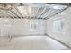 Unfinished basement displaying sealed walls, concrete flooring, and windows, perfect for future expansion and customization at 20724 E 57Th Ave, Aurora, CO 80019