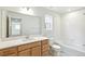 Modern bathroom featuring a vanity, large mirror, and a tub with tile surround at 20724 E 57Th Ave, Aurora, CO 80019
