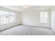 A bedroom with carpeted floors, two windows, and an overhead light at 20724 E 57Th Ave, Aurora, CO 80019