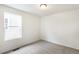 An empty bedroom with carpeted floors and a window overlooking the backyard at 20724 E 57Th Ave, Aurora, CO 80019