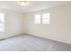 Bedroom with carpeted floors and two windows offering natural light and neighborhood views at 20724 E 57Th Ave, Aurora, CO 80019
