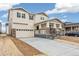 Charming two-story home featuring neutral siding, stone accents, covered porch, and a two car garage at 20724 E 57Th Ave, Aurora, CO 80019