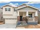 Home exterior boasting stone accents, a covered front porch, and an attached garage, enhancing its curb appeal and functionality at 20724 E 57Th Ave, Aurora, CO 80019