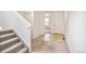 Hallway with carpeted stairs leading to an upper level; a tiled floor leads to the front door at 20724 E 57Th Ave, Aurora, CO 80019
