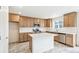 Kitchen features stainless appliances, white countertops and backsplash, ample cabinetry, and large island at 20724 E 57Th Ave, Aurora, CO 80019