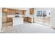 Bright kitchen features stainless appliances, white countertops and backsplash, and a kitchen island at 20724 E 57Th Ave, Aurora, CO 80019