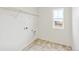 Laundry room featuring a window, tiled floors, and washer/dryer hookups at 20724 E 57Th Ave, Aurora, CO 80019