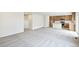 Spacious living room with neutral walls, modern carpeting, and an open layout flowing into the kitchen at 20724 E 57Th Ave, Aurora, CO 80019