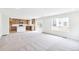 Bright living room with modern carpet and open access to kitchen with island and stainless appliances at 20724 E 57Th Ave, Aurora, CO 80019