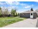 Backyard featuring a well-maintained lawn and detached garage at 10752 Blue Jay Ln, Northglenn, CO 80233