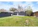 Large backyard with green grass and a detached garage at 10752 Blue Jay Ln, Northglenn, CO 80233