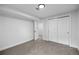 Bedroom featuring neutral carpet, white walls, and closet with sliding doors at 10752 Blue Jay Ln, Northglenn, CO 80233