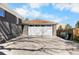Spacious garage with a white door and concrete driveway at 10752 Blue Jay Ln, Northglenn, CO 80233