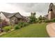Beautifully landscaped backyard with low-maintenance artificial grass at 8107 Arapahoe Peak St, Littleton, CO 80125