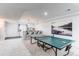 Entertaining basement area featuring a ping pong table, bar seating, and stylish decor for relaxation and fun at 8107 Arapahoe Peak St, Littleton, CO 80125