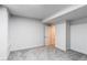 Spacious basement with neutral carpet and freshly painted white walls and trim at 8107 Arapahoe Peak St, Littleton, CO 80125